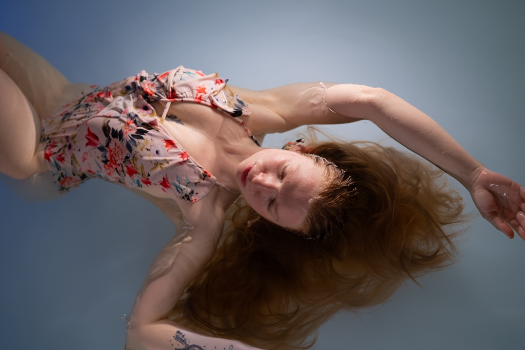 FLOAT ONE guest floating with her arms relaxed above her head